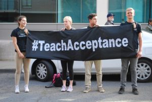 Youth with sign Teach Acceptance